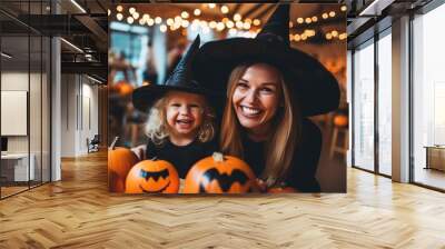 Happy family preparing for Halloween! Young mom and her kid in carnival costumes celebrate the holidays. Wall mural