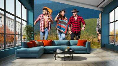 Happy friends walking on mountain. Friends spring travel vacation banner. Group of hikers on the top of the mountain. Friendship freedom summer holiday concept. Wall mural