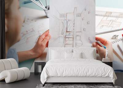 Interior designer holding hand drawing pencil sketch of a bathroom Wall mural