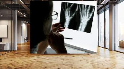 Surgeon Traumatologist  examining an x-ray of the traumatised wrist. Wall mural