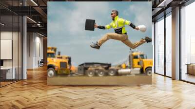 Hispanic 40 s builder excited jump on site construction. American middle aged man builder. Millennial construction builder near at building. Portrait of builder worker man near construction building. Wall mural