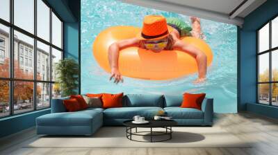 Kid boy relaxing in pool. Child swimming with float ring in water pool. Wall mural