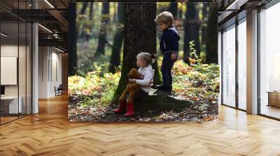 Kids activity and active rest. Brother and sister have fun on fresh air. Children play in autumn forest. Childhood and child friendship, love and trust. Little boy and girl friends camping in woods Wall mural