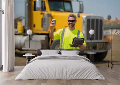 Man driver with lunch box. Truck driver having lunch. Handsome middle aged man trucker trucking owner. Transportation industry vehicles. Handsome man driver front of truck. Wall mural