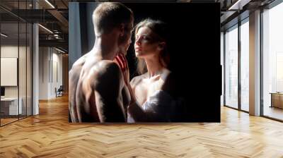 Man embracing and going to kiss sensual woman. Loving couple kissing over black background. Couple in love going for the kiss. Wall mural