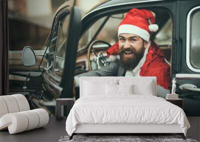 Man in red hat deliver xmas gifts in retro car Wall mural