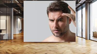 Mens beauty cosmetics, male beauty and skincare. Morning healthcare and hygiene for man. Perfect beauty skin. Handsome millennial man after shower apply facial cream or mask on skin. Wide banner. Wall mural