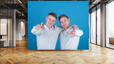 Models standing on blue background Wall mural