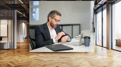 Office workplace. Handsome business man working with laptop at desk in office. Businessman typing on keyboard, online business meeting. Businessman working in office. Office worker using laptop. Wall mural