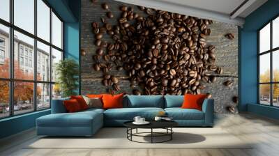 Roasted arabica coffee beans scattered on a wooden table. Fresh coffee beans. Wall mural