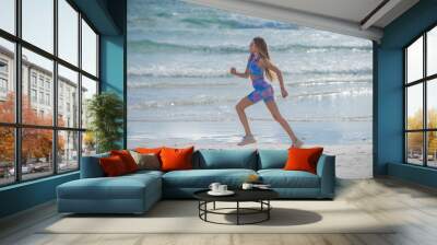 Running woman jogging on beach. Fit woman doing workout on sea sand summer beach. Summer sport. Fitness female sport model jog lifestyle. The Running. Fit girl run on beach. Wall mural