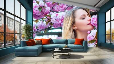 Sensual woman near sakura tree background, banner for website header. Passion and sensual touch. Beauty spring girl with blooming sakura cherry Flover. Wall mural