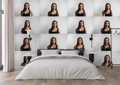 Set of young woman's portraits with different emotions. Young beautiful cute girl showing different emotions. Laughing, smiling, anger, suspicion, fear, surprise. Wall mural