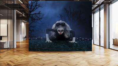 the girl wearing with horns. halloween make up. little girl scared on the background of the night Wall mural