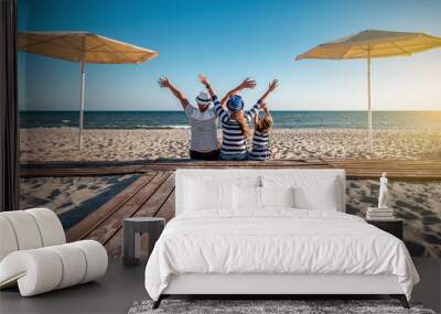 funny family in striped clothes at the beach Wall mural