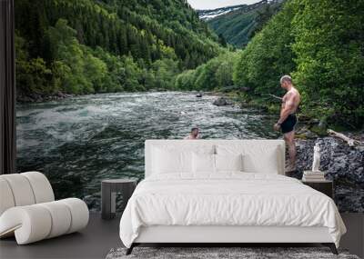 two men swim in a mountain river Wall mural