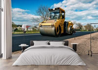 yellow road roller makes new asphalt Wall mural