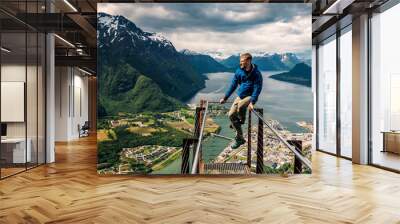 young man is sitting on rampestreken in Norway Wall mural