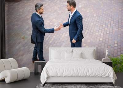 Successful teamwork. Business people shaking hands. Two businessmen shaking hands outdoors. Shaking hands. Management strategy. Handshake between two businessmen. Teamwork. Wall mural