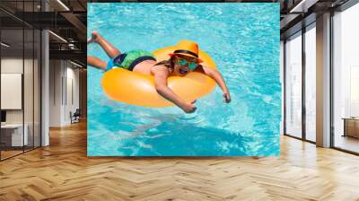 Summer fun kids face. Kids splashing in swimming pool. Swim water sport activity on summer vacation with child. Child water toys, floating ring. Wall mural