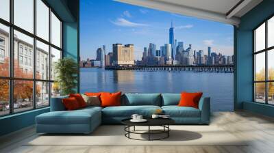 The city skyline of New York City in USA, United States. Blue sky day with iconic buildings. New York City NYC Manhattan Downtown Skyline, viewed from Jersey City, USA. Wall mural