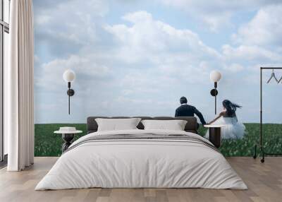 wedding couple on green grass and blue sky Wall mural