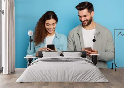 woman and man with phone on blue background . Wall mural