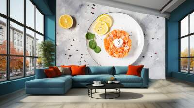 Delicious avocado and salted salmon tartar on concrete background Wall mural