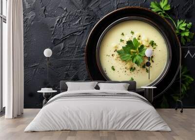 Bird s eye view of creamy potato soup in a bowl on black background Wall mural