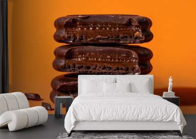 Bitten chocolate alfajor on orange surface Wall mural