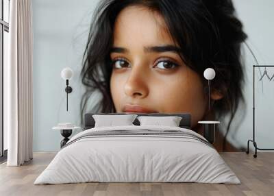 Closeup portrait of a stunning Indian girl with flawless skin wearing makeup Emphasizing beauty health and care Isolated on a white background Wall mural