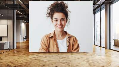 Confident woman in casual attire joyfully poses and smiles against white backdrop Wall mural