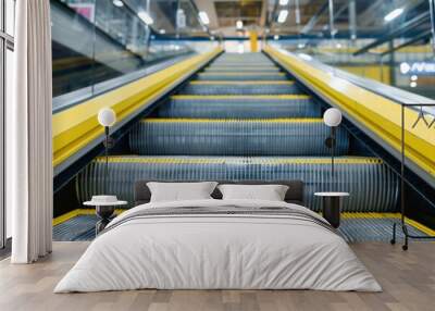 Electric escalator in shopping center with yellow and gray steel lines Wall mural