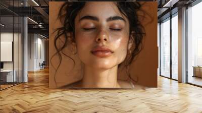 Indian female model applies hyaluronic acid retinol and essential oil for healthy skin in a studio Wall mural