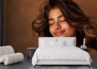 Indian woman with beautiful brown hair and makeup posing in a salon with a studio background showcasing her stylish hairstyle and happy expression after receivi Wall mural