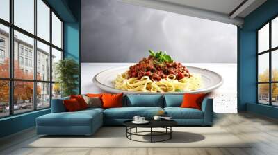 Italian pasta dish with bolognese sauce made from meat and tomato on a light grey background with copy space Wall mural