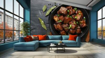 Top view of Pork Adobo in black bowl on dark slate background Traditional Filipino dish made with braised pork belly soy sauce vinegar and spices Wall mural