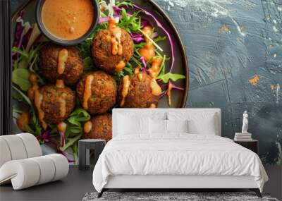 Top view of vegetarian falafel balls on a plate with sauce Wall mural