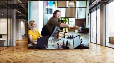 Diverse colleagues shaking hands at office meeting Wall mural