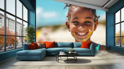 Portrait of a smiling little girl with sunscreen at the beach Wall mural