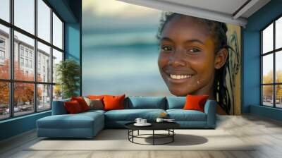 Portrait of a young African American female surfer on the beach Wall mural