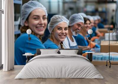 Smiling group of factory workers packaging products Wall mural