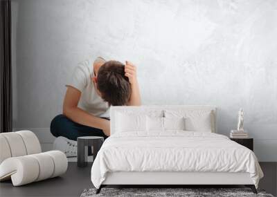 a child whose depression is sitting on the floor Wall mural