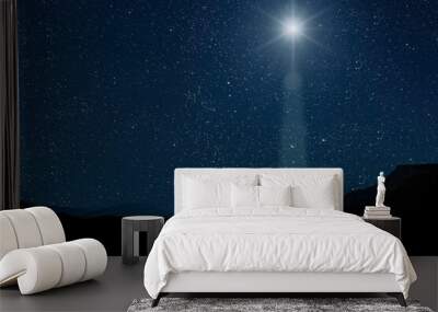 A christmas star shines at night over the mountains of Bethlehem Wall mural