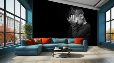 child whose depression is on a black background Wall mural