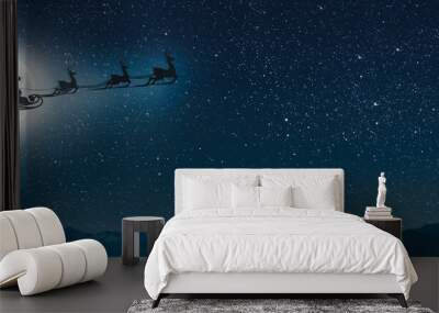 silhouette of a flying goth santa claus against the background of the christmas night sky. Wall mural