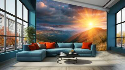 Panoramic landscape of fantastic sunset in the mountains. View of the autumn hills lit by the rays of the evening sun. Dramatic clouds over sky. Wall mural