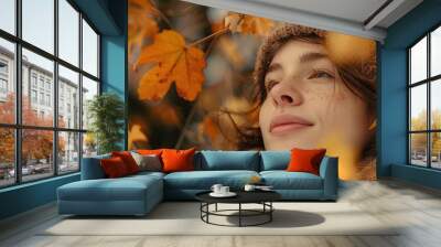 Portrait of a girl in a knitted yellow hat against an autumn landscape. Wall mural