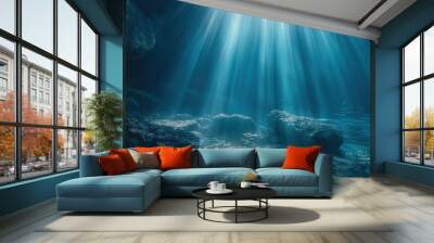 The sun's rays underwater illuminate the seabed. Underwater background with sun rays. Blue ocean or sea depth blue background. Wall mural