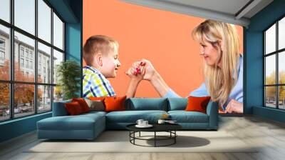  Mother and son arm wrestling. Wall mural